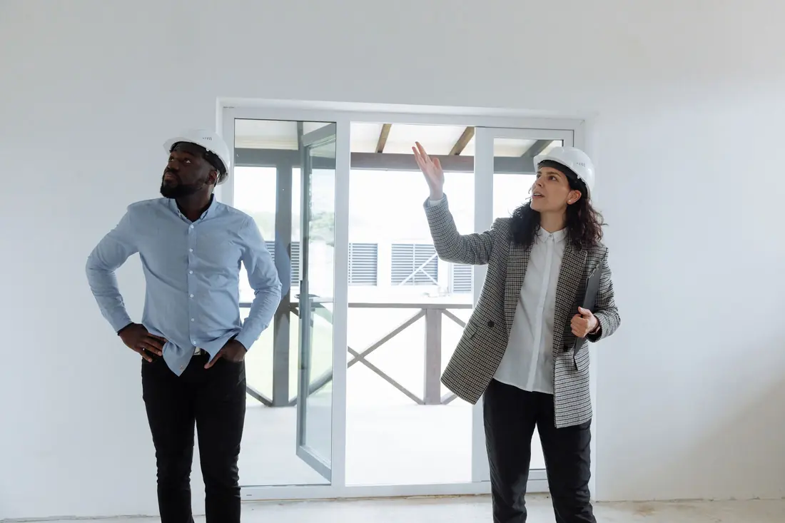 Buyer walking through an empty house with a professional before purchase
