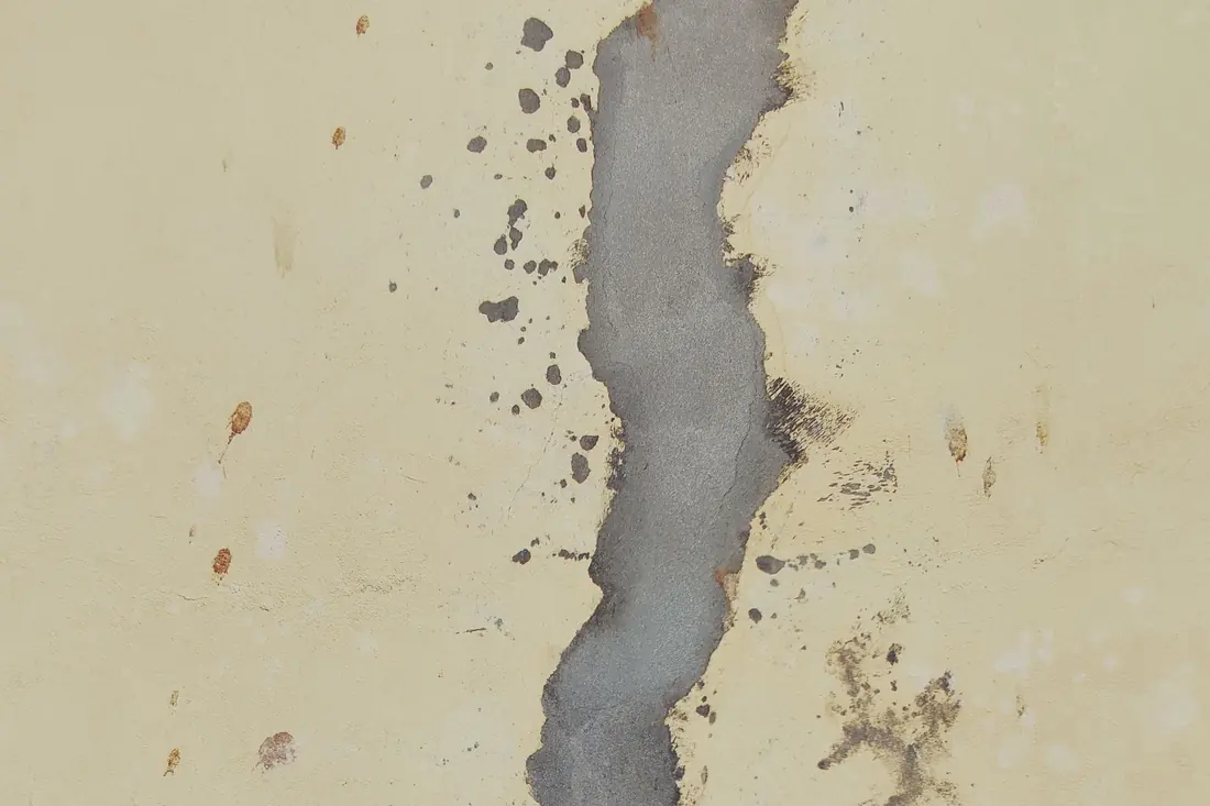 Crack in a concrete foundation wall being documented during an inspection